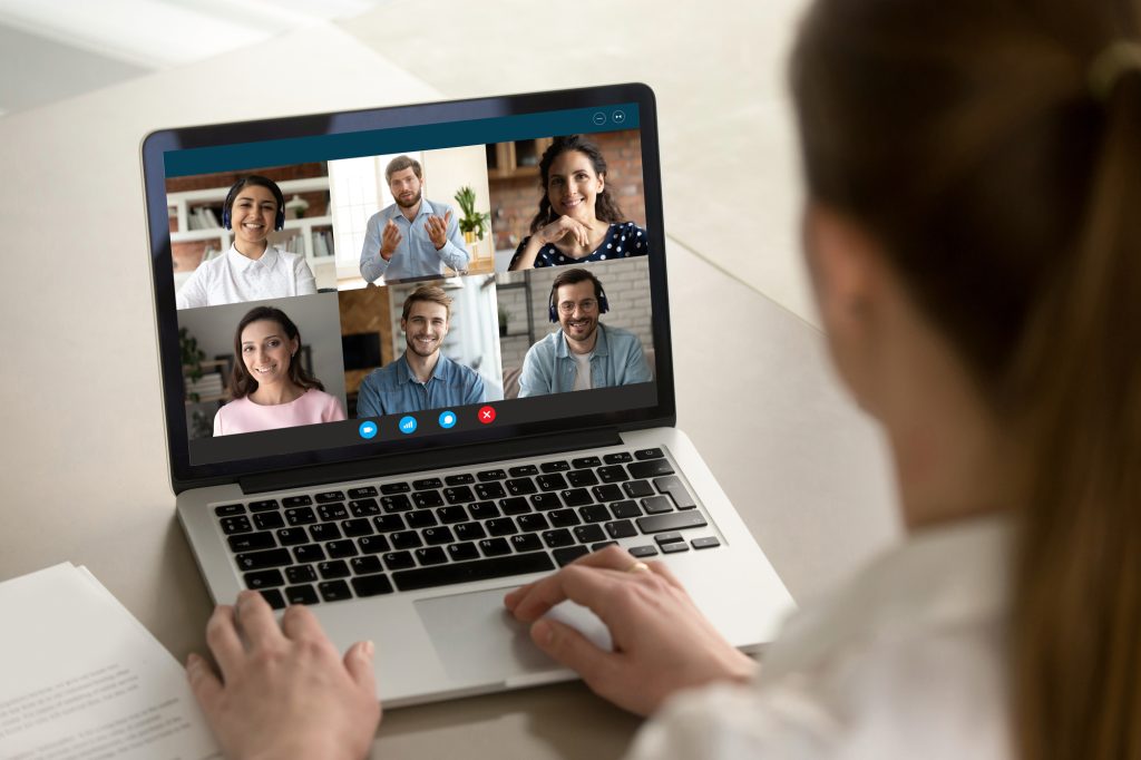 Female Employee Talk On Video Call With Diverse Colleagues