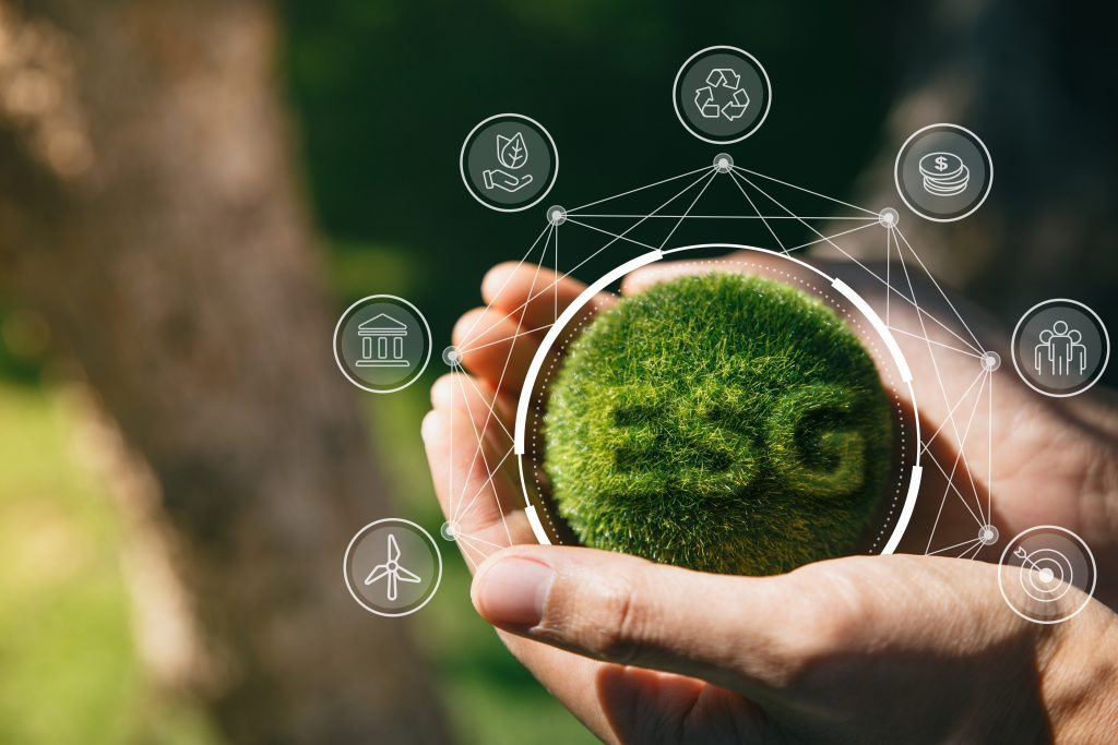 Hand of human holding green earth ESG icon for Environment Socie